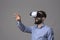 Amazing virtual reality experience of young business man wearing vr glasses and gesturing screen by hand