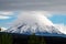 Amazing volcanic landscape - view of the snow-capped cone of the Bolshaya Udina