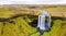 amazing waterfall falling in the middle of a mountain in iceland aerial view from a drone