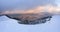 Amazing winter dramatic sky. Fantastic sunrise. Panoramic view of the covered with frost trees in the snowdrifts, mountain.