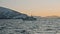 Amazing winter fjord view at golden sunset. Arctic ship with people watching for two migrating humpback whales