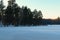 Amazing winter landscape of frozen pond in the forest. Evergreen wood and shore in snow. Winter season in the Pushcha-Vodytsia.