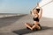 Amazing young sports woman make yoga exercises meditate outdoors on the beach.