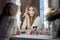 Amazing young woman doing her makeup in front of mirror. Portrait of beautiful girl near cosmetic table