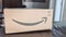 Amazon deliver logo sign arrow smiling printed on brown cardboard box delivery side