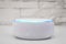 Amazon echo dot , Alexa voice controlled speaker with activated voice recognition, on brick and white background