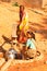 Ambaji: Two young indian women filling their water-bowls