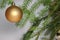 Amber ball on the Christmas tree on a white background. gemstone amber shimmers in the light. orange light. Christmas decorations