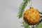 Amber ball on the Christmas tree on a white background. gemstone amber shimmers in the light. orange light. Christmas decorations