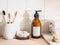 Amber bottle skin care with white labels, bamboo toothbrush and various accessories on beige table and wall white tiles