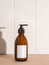 Amber bottle with white label mockup for bathing products in bathroom, spa shampoo, shower gel, liquid soap