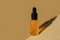 Amber cosmetic oil bottle with black dropper cap on beige paper background. Horizontal mockup, banner, poster, copy space. Glass