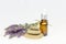 Amber essential lavender oil bottle. Pipette with drop and bottle on an isolated background.