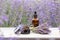 Amber essential lavender oil bottle. Violet lavendar field in Provence.