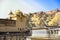 Amber Fort with golden sun light and green mountain as a background, Rajasthan, India