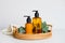 Amber glass liquid soap dispenser bottles and eucalyptus in rattan tray on table in bathroom. SPA organic natural cosmetic