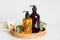 Amber glass pump bottles of shampoo and liquid soap in rattan tray.