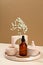 Amber glass spray cosmetic bottle and modern DIY concrete home decor on beige background