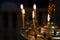 Ambiance of church, light of candles. Candles in a church. Light of candles in the church on the dark background