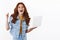 Ambitious cheerful redhead girl in denim jacket, hold laptop, smiling happily, achieve goal, fist pump relieved