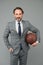 Ambitious coach. Business coach hold basketball ball. Basketball coach grey background. Confident coach or teacher in