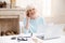 Ambitious elderly lady managing the project from home