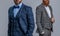 ambitious men in tuxedo menswear suits. men in tuxedo menswear isolated on grey.