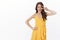 Ambitious sassy good-looking female model in yellow dress, wink coquettish and smiling assertive, show peace victory