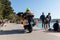 Ambulance motorbike on a busy beach road full of people in hot summer