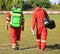 Ambulance staff with medical equipment on a sport track