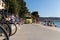 Ambulance van on a busy beach road full of people in hot summer