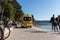 Ambulance van on a busy beach road full of people in hot summer