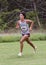 Amerasian teenageboy racing up a hill in a 5 kilometer race in Stillwater, Oklahoma.