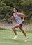 Amerasian teenageboy racing up a hill in a 5 kilometer race in Stillwater, Oklahoma.