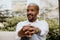 American african confident businessman in white shirt pointing hand to camera and smiling outside corporate office.Peace