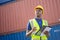 American African engineer or factory worker man working  at Container cargo harbor to loading containers. African dock male staff