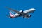 An American Airline jet against a blue sky background