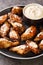 American Alabama White Sauce Chicken Wings closeup in the plate. Vertical
