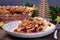 American apple cranberry pie, topped with crumbled dough and pecan, slice on plate