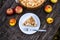 American apple Tsvetaevsky jellied open pie piece on a plate, close-up, on a dark wooden background. Flat lay