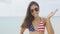 American Asian woman waving with USA flag bikini