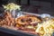 american barbecue tray with porchetta, pulled pork, coleslaw salad, brisket, barbecue sauce, pulled pork dumpling, french fries,