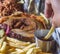 american barbecue tray with porchetta, pulled pork, coleslaw salad, brisket, barbecue sauce, pulled pork dumpling, french fries,