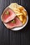 American beef steak with a fried potato slices close-up on a plate. vertical top view