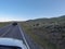 American Bison Grazing by Roadside With Passing Cars