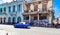 American blue Buick classic car drives before a house facade with graffiti in Havana City Cuba - Serie Cuba Reportage