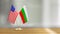 American and Bulgarian flag pair on a desk over defocused background