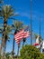 American and Californian flags flying at half mast