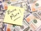 American cash money and yellow post it note with text Earn More