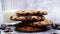 American chocolate chip cookies, milk is poured into a glass in the background on a gray background. Traditional round crispy doug